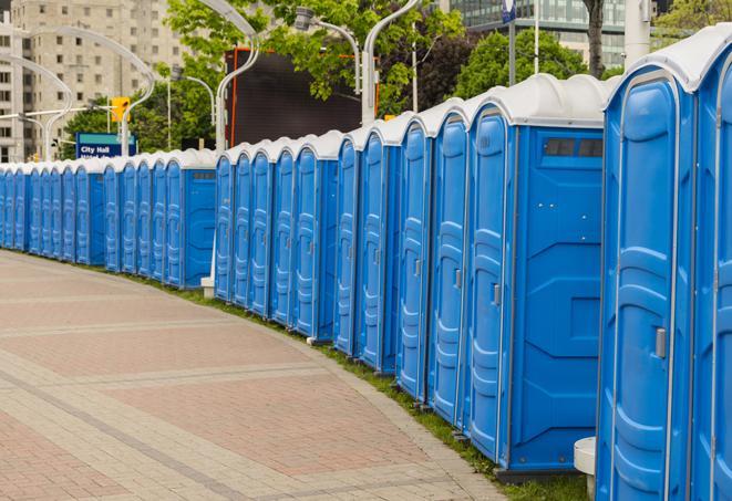 a fleet of portable restrooms ready for use at a large outdoor wedding or celebration in Louisville